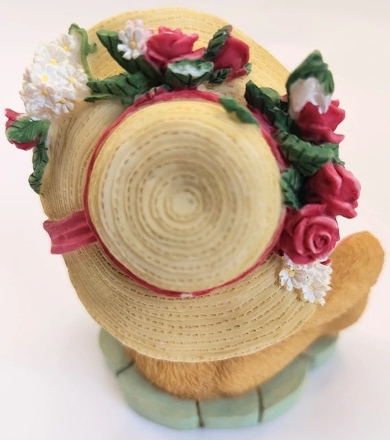 Decorative straw hat with floral embellishments on a white background