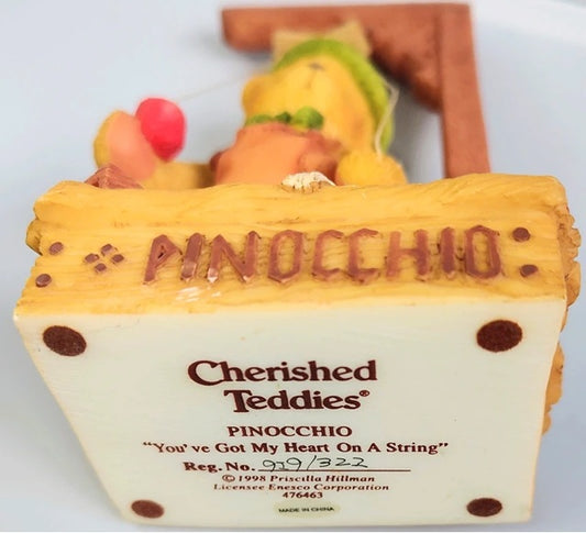 Pinocchio figurine with 'Cherished Teddies' branding on a white background