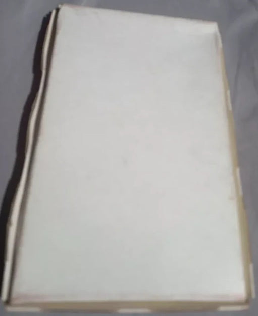 White rectangular object with a black border on a gray background