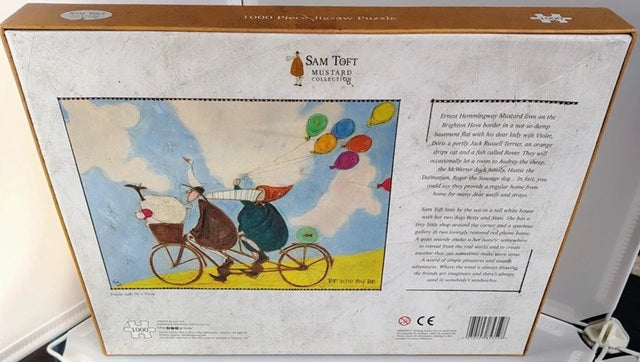Back of bo showing person and dog on a bicycle.