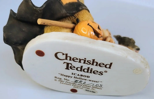 Halloween-themed Cherished Teddies figurine with a label on a white background
