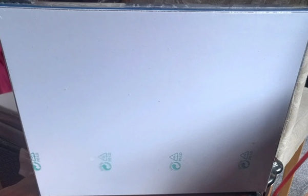 White sheet of paper with green logos on a surface