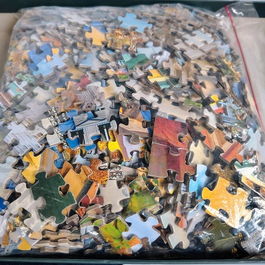 Pile of assorted puzzle pieces in a clear plastic bag