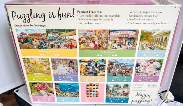 Back of a jigsaw puzzle box showing multiple puzzle designs and product features.
