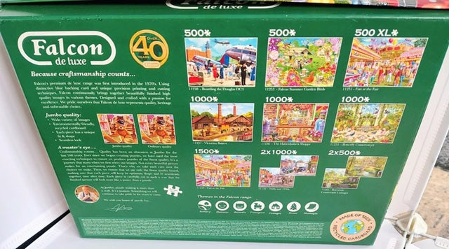Green box of Falcon de luxe puzzles with images and text on a white background