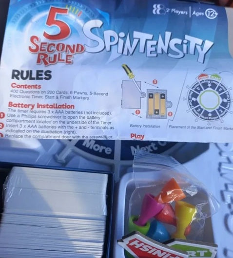 Spintensity game packaging with cards and markers on a white background