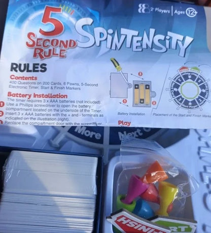 Spintensity game packaging with cards and markers on a white background