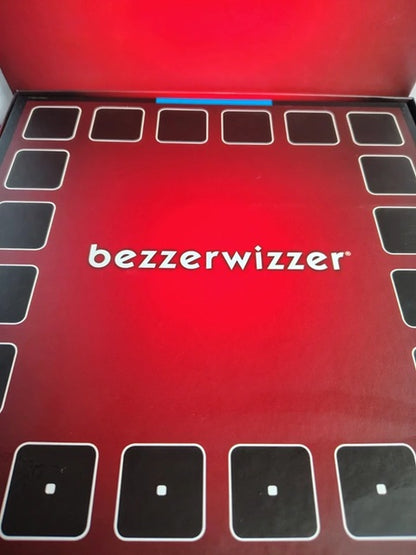 The red and black packaging box for the game 'bezzewizzer', featuring the white brand name in the center and black squares outlining the play area.
