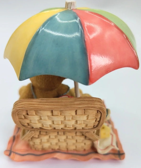Decorative item with a colorful umbrella and wicker basket on a white background