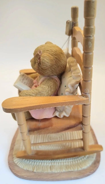 Cherished Teddies figure of a bear reading a book on a swing