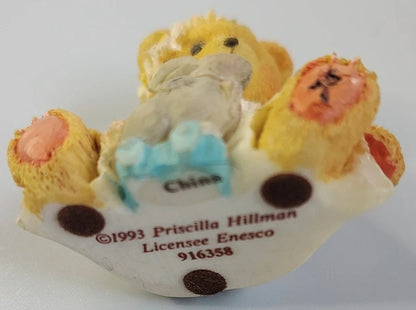 Decorative bear figurine with a bear holding a rabbit.