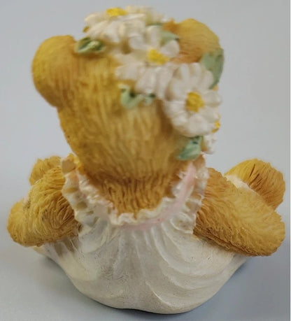 Cherished teddy bear with a floral headband on a white background