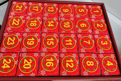 Red advent calendar with numbers on a wooden box