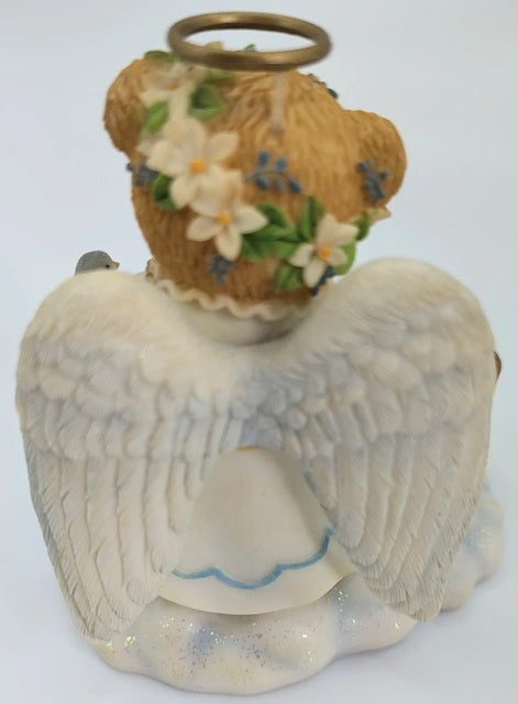Decorative angel figurine with a basket of flowers on a white background