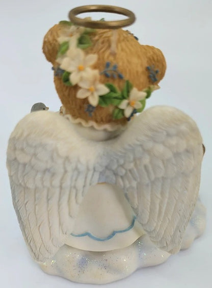 Decorative angel figurine with a basket of flowers on a white background