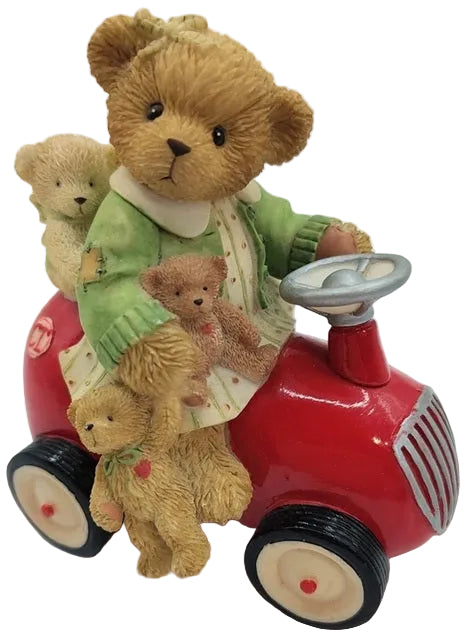 Cherished Teddies Roxanne. Teddy bear driving a red toy car with smaller teddy bears on board, on a white background