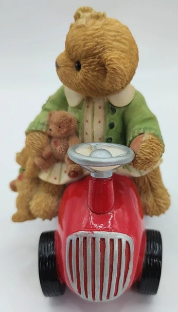 Teddy bear with a teddy bear in a car toy on a white background