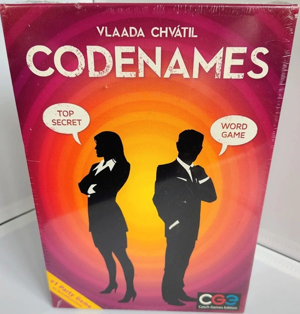 Board game box for 'Codenames' with silhouettes of a man and a woman on a gradient background.