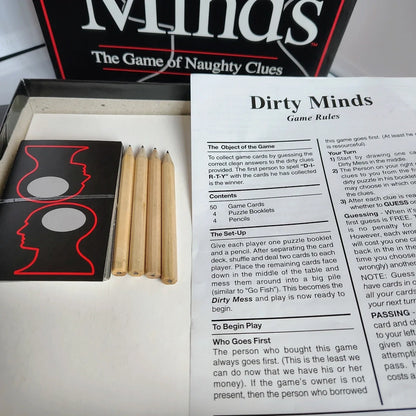 Dirty Minds game box with game rules and pencils on a white background