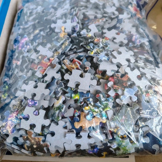 Pile of puzzle pieces in a clear plastic bag with a visible brand logo.
