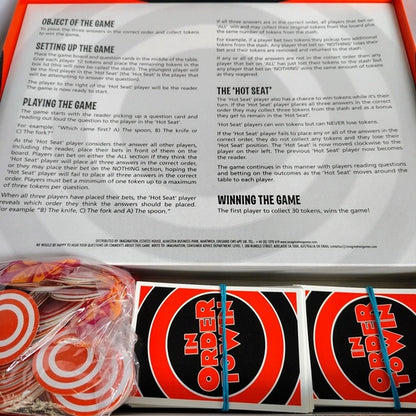 Game instructions and components including tokens and a board with 'In Order Town' branding.