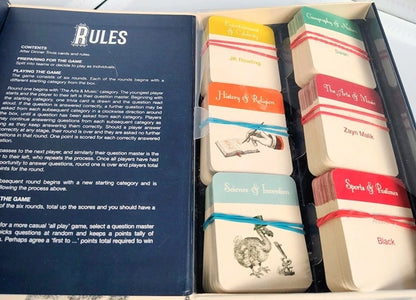 Set of question cards in a box, featuring game rules on a blue card.