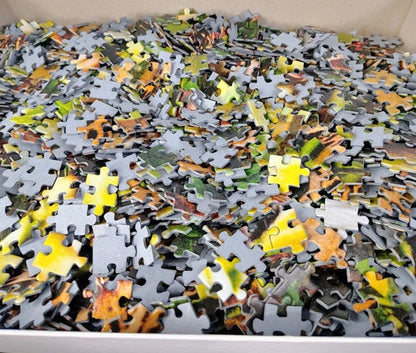 Pile of assorted puzzle pieces on a flat surface