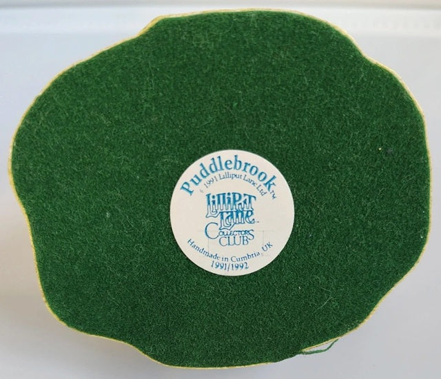 Green felt coaster with a circular label on a white background