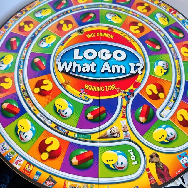 Colorful board game spinner with 'Logo What Am I?' branding
