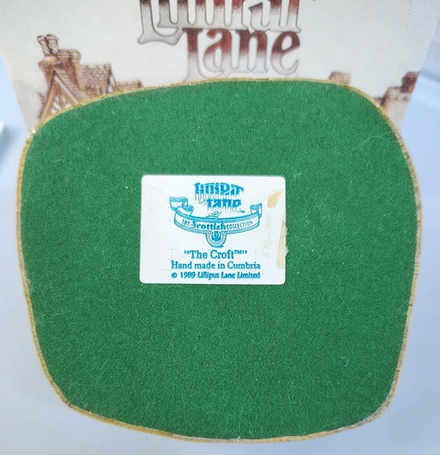 Green felt product with a label on a white background, featuring the Lilliput Lane brand.