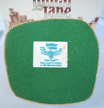 Green felt product with a label on a white background, featuring the Lilliput Lane brand.