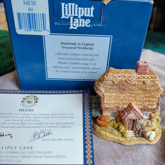 Lilliput Lane miniature house with packaging and certificate on a table