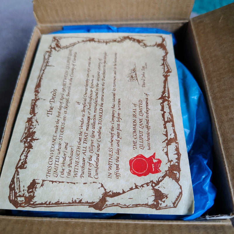 Card with text and a red seal in an open box