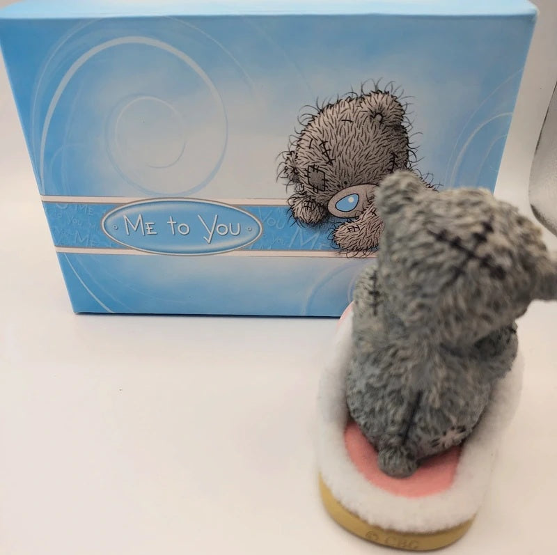 A Me to You resin figurine in a sitting pose, displayed in front of its blue branded packaging box on a white surface.