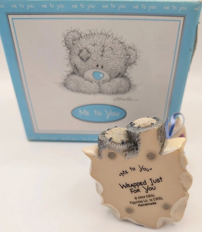 A Me to You 'Wrapped Just For You' teddy bear ornament in the foreground, with its original blue and white illustrated box behind it on a white background.