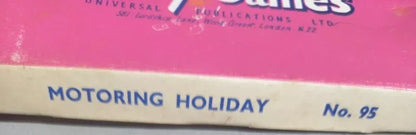 Vintage box with 'Motoring Holiday' text and a pink background