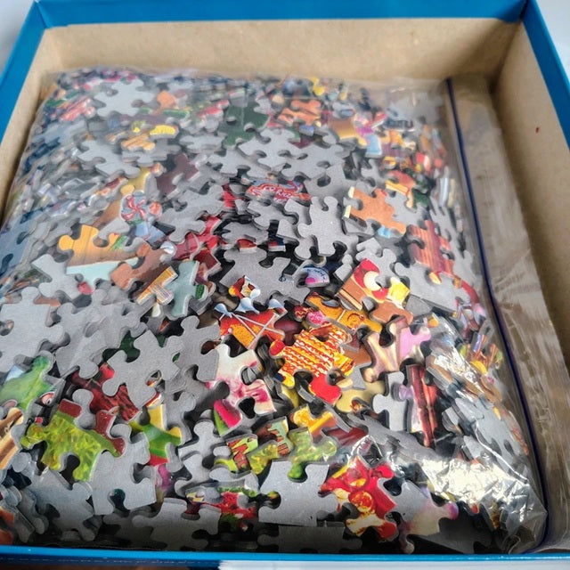 Jigsaw puzzle pieces in a box with colorful puzzle pieces.