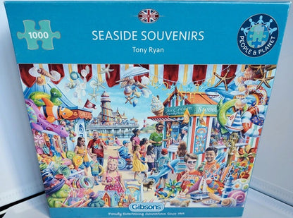 Colourful seaside scene from the Seaside Souvenirs 1000 piece jigsaw puzzle with shops, people and a pier.