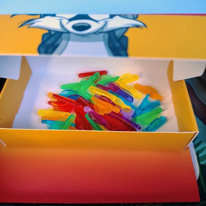 Colorful plastic tools in a box with a cartoon character on a blue background