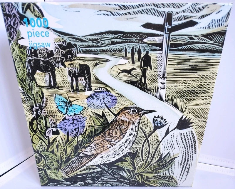 The Common Jigsaw Puzzle Angela Harding. A 1000-piece jigsaw puzzle featuring a vintage-style linocut illustration of a rural landscape with horses, a bird, butterflies, flowers, and figures along a winding path. The puzzle box shows the text '1000 piece jigsaw' in blue in the upper left corner.