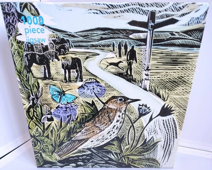 The Common Jigsaw Puzzle Angela Harding. A 1000-piece jigsaw puzzle featuring a vintage-style linocut illustration of a rural landscape with horses, a bird, butterflies, flowers, and figures along a winding path. The puzzle box shows the text '1000 piece jigsaw' in blue in the upper left corner.