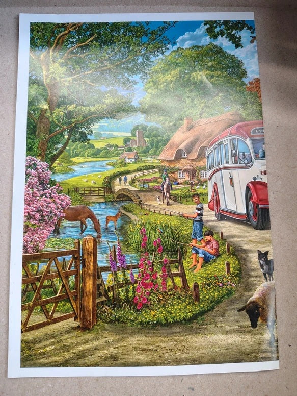 A colorful landscape art print depicting a whimsical countryside scene with a red and white vintage bus, a river, flowers, trees, and people by the water, shown against a neutral background.