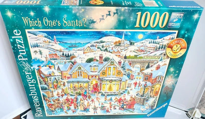 Ravensburger 1000-piece jigsaw puzzle box titled 'Which One's Santa?' showing a snowy village scene with houses, people, sleighs, and Santa in the illustration. The box is photographed indoors on a light surface.
