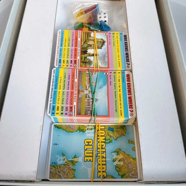 Collection of trading cards in an open card holder with glue stick visible.