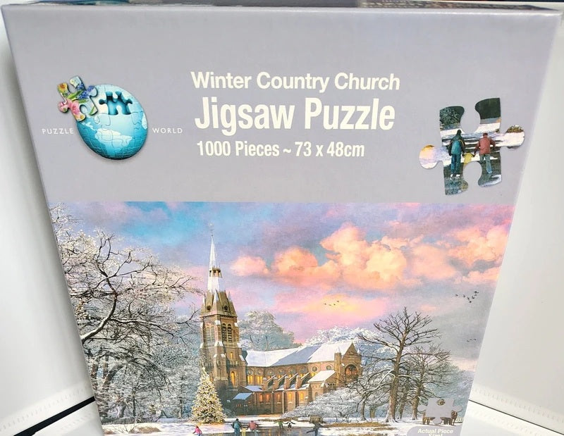 Box of a 1000-piece jigsaw puzzle titled 'Winter Country Church' from Puzzle World. The packaging features a colorful winter landscape illustration of a church in snow with pink and blue sky, and a small inset showing assembled puzzle pieces.