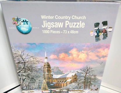 Box of a 1000-piece jigsaw puzzle titled 'Winter Country Church' from Puzzle World. The packaging features a colorful winter landscape illustration of a church in snow with pink and blue sky, and a small inset showing assembled puzzle pieces.