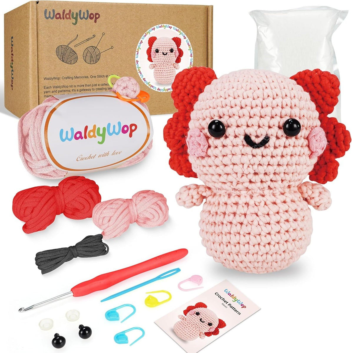WaldyWop Newt Crochet kit with a completed amigurumi toy, yarn, hooks, and patterns on a white background.