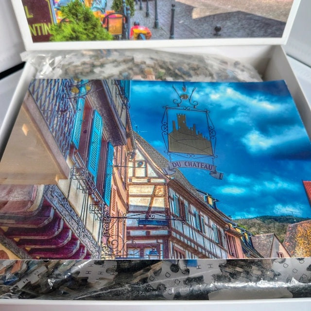 Collage of images including a colorful street scene, a blue sky with clouds, and a scenic view of buildings.