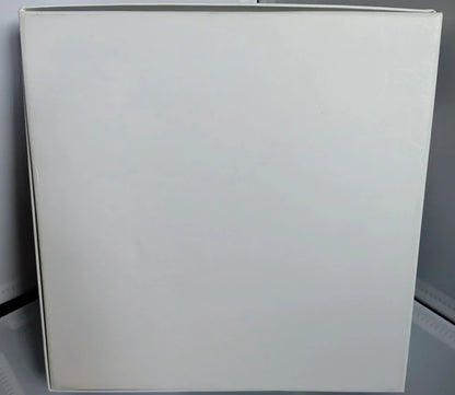 White rectangular object on a gray surface with a white background