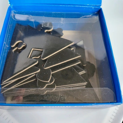 Black metal puzzle pieces in a blue box